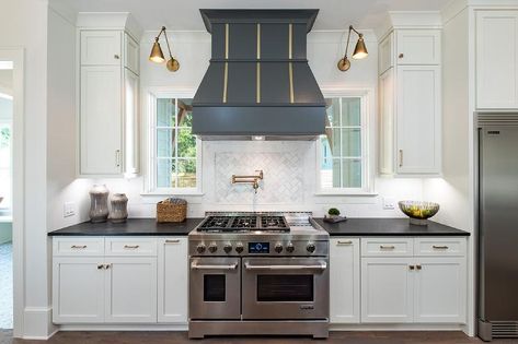 Stunning cooktop designed with a black French wood range hood accented with brass trim. Metal Range Hood, Wood Range Hood, Custom Range Hood, Kitchen Hoods, Kitchen Range, Transitional Kitchen, Kitchen Inspiration Design, Farmhouse Style House, Range Hood