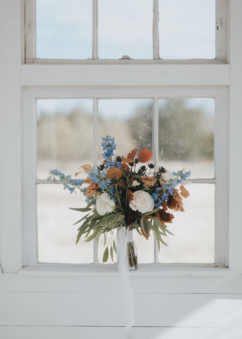 Pops of blue in the fall…yes please!!! When Julep Events reached out about renting our Farm Tables & tabletop beauties for their client’s wedding at Davis & Grey Farms in Celeste, TX, we were secretly praying behind-the-scenes they would say yes to our rentals! And they did!!! Julian & Anastasia’s wedding day was nothing short of stunning! Powder Blue Fall Wedding, Dusty Blue And Burnt Orange Wedding Bridal Bouquets, Fall Flowers With Blue, Fall Blue Bouquet, Dusty Blue Autumn Wedding, Blue Green Fall Wedding, Fall Wedding Ideas Blue, Dusty Blue And Amber Wedding, Cornflower Blue Fall Wedding