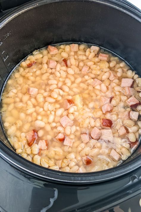 Take a trip down memory lane with this classic Old Fashioned Ham and Beans Stew. Made with slow-cooked ham, tender navy beans and a blend of spices, this stew is the ultimate comfort food. Perfect for a chilly day or a casual family dinner. Serve with crusty bread for a satisfying meal. Ham And Bean Soup Recipes Stovetop, Navy Beans And Ham Crockpot, Ham And Beans Stovetop, Food For A Cold Day, Old Fashioned Ham, Navy Beans And Ham, Country Fried Pork Chops, Slow Cooked Ham, Ham Hocks And Beans