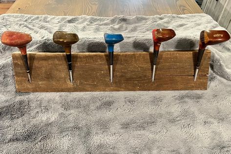 "Vintage golf clubs repurposed for a functional coat or hat rack using barn wood for a mountable surface. This item is one of kind. Some scratches and dings are present on the golf clubs to add character and authenticity. The barn wood is not sanded smooth in order to keep a rustic look and feel. 27.25\" wide X 9\" tall X 5.75\" deep" Golf Club Hat Rack, Golf Club Coat Rack, Old Golf Clubs Ideas, Repurposed Golf Clubs, Old Golf Clubs Ideas Decor, Wooden Golf Clubs, Hat Rack Wall, Vintage Golf Clubs, Club Decor