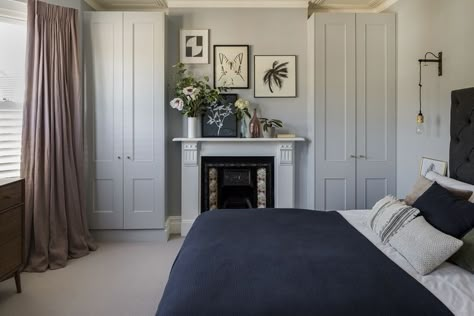 Interior Design by Imperfect Interiors at this Victorian terraced house in Balham, London. A palette of contemporary paint colours mixed with traditional period details- Paint & Paper Library Lead 5 on the walls, charcoal grey fabric headboard, washed linen curtains, white fireplace & Buster & Punch brass wall lights make the master bedroom feel grown up and luxurious. Photo by Chris Snook Grey Fabric Headboard, Linen Curtains White, Contemporary Paint Colors, Balham London, Terrace Interior, Brass Wall Lights, Victorian House Interiors, Curtains White, Victorian Terraced House