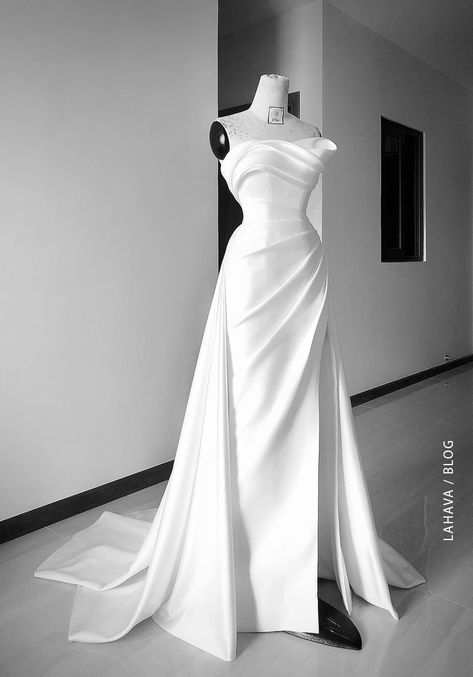 Minimalist wedding dress is always a different choice for brides who love simplicity, classic, and elegance. While the gorgeous beaded princess wedding gowns, the minimalist wedding dress focuses mainly on the silhouettes. Delicate draping and high-quality materials have made many brides fall in love with this style. As a minimalist bride, you'll likely be drawn to simple and classic silhouettes like pared-back slip dresses, unadorned ball gowns, and courthouse-chic mini dresses. Or perhaps you Draped Bridal Gown, Wedding Dresses Minimalist, Minimalist Bridal Gown, Minimalist Wedding Gown, Tailored Wedding Dress, Minimalist Wedding Dress, Weddding Dress, Minimalist Gown, Wedding Dress Alterations