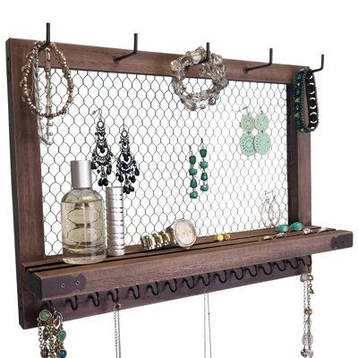 This wall jewellery organizer wall mounted can securely hold your daily jewellery essentials. It with added brackets in the back for your dangle earrings, and it is bigger than most competitors. Save space on your vanity dresser and accentuate your vintage room decor with this wall jewellery organizer where you can see all your cute necklaces, earrings, bracelets, watches, and hair accessories and easily pick out what to wear. Millwood Pines | Millwood Pines Wall Hanging Jewellery Organizer | Ru Jewelry And Sunglasses Organizer, Picture Frame Jewelry Display, Boho Jewelry Organizer, Western Jewelry Organizer, Western Jewelry Holder, Picture Frame Jewelry Holder, Bedroom Nooks, Diy Jewelry Wall, Necklace Organization