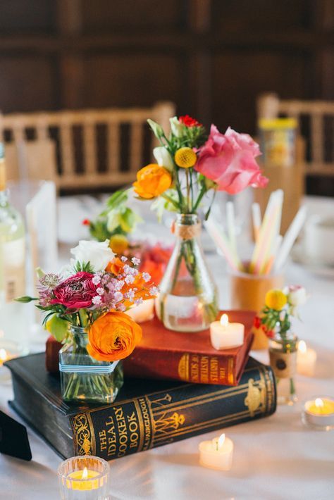 Pretty vintage books repurposed as colorful centerpieces… | 19 Gorgeous Things Every Book Lover Needs For Their Wedding Book Wedding Centerpieces, Historic Library, Flowers In Vases, Unique Wedding Centerpieces, Book Centerpieces, Jenny Smith, Book Themed Wedding, Colorful Centerpieces, Literary Wedding