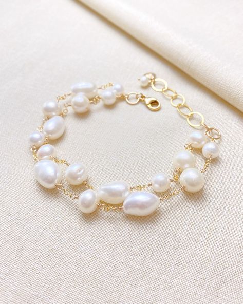 Make a classic and elegant statement with this multi-layered mixed pearl bracelet. Two handcrafted strands of differently shaped and sized pearls create a versatile accessory suitable for weddings, brunches, work, and more. The lobster clasp and extender ensure a secure and adjustable fit. Length: 7.5 inches plus 1.5 inch extender Materials: gold fill, cultured freshwater pearls Gift box included. Bracelet Clasps Ideas, Journal Lettering, Pearl Bracelet Gold, Pearl Gifts, Pearls Diy, The Lobster, Silver Jewelry Necklace, Adjustable Jewelry, Freshwater Pearl Bracelet