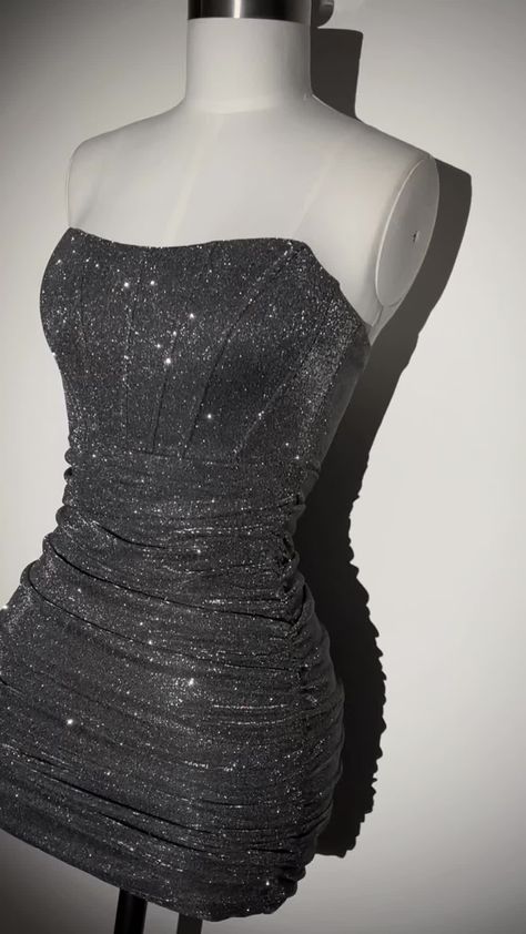 The Blair Glitter Lurex Mini Dress is your must have for party season. Featuring a structured corset design with added boning to give you a cinched in silhouette and extra ruched detailing for the most stunning figure-hugging fit. The Dark Grey corset dress is the perfect mini for your birthday outfit and will ensure all eyes are on you. Pair with sparkly heels and matching silver jewellery for the most perfect fit. Zip fastening Corset design Boning detail Strapless Dark Grey glitter fabric Our Dark Grey Hoco Dress, Stary Night Hoco Dress, Silver Dress Ideas, Dress Hoco Short, Euphoria Homecoming Dress, Gray Hoco Dresses, Birthday Black Dresses, Diamond Homecoming Dress, Silver Dress Homecoming