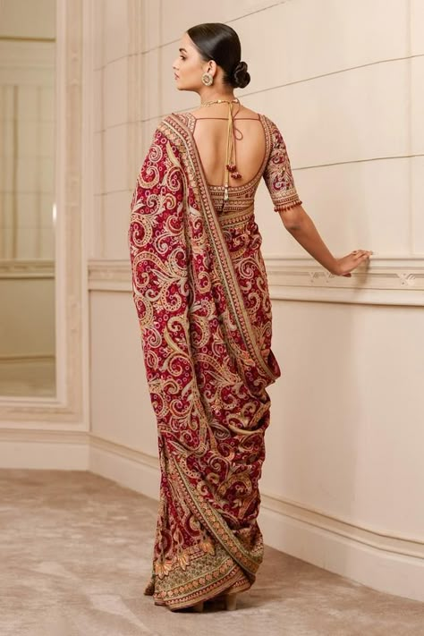 Maroon printed saree in georgette that is highlighted with kashida embroidery all-over. Paired with a embroidered blouse with crystal tassels on the sleeves. Component: 2 Pattern: Printed, Embroidered Type Of Work: Floral, Paisley, Kashida Neckline: Leaf Sleeve Type: Tassel Fabric: Blouse - Silk Dupion, Saree - Double Georgette Color: Maroon Other Details:  Printed base Kashida embroidery Back tassel tie-up Note: Bag shown in the image is not for sale Occasion: Bride,Wedding - Aza Fashions Tarun Tahiliani Saree, Manish Malhotra Bridal, Kashida Embroidery, Marriage Dress, Maroon Blouse, Traditional Indian Dress, Embroidered Saree, Tarun Tahiliani, Saree Trends