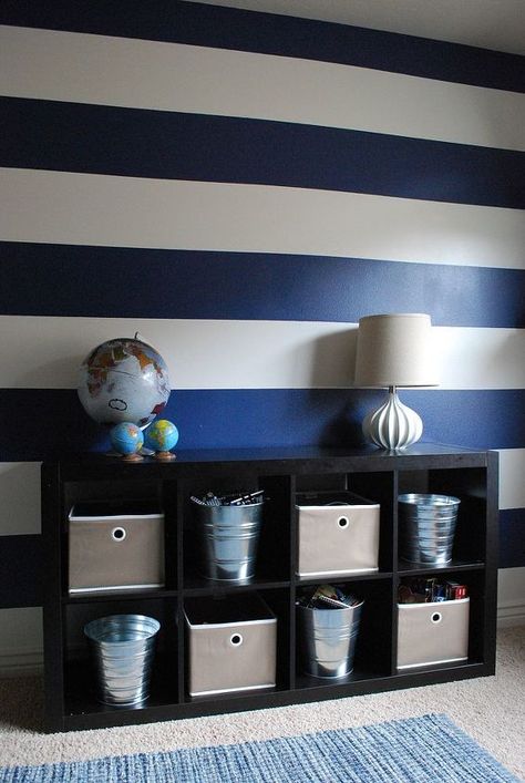 The use of bold blue and white stripes in my boys' bedroom creates a lot of personality without breaking the bank. The room is fun, vibrant, and full of energy just like its inhabitants. The bookcase is from IKEA and the cardboard deer head is from Cardboard Safari. Striped Accent Wall, Townhouse Decorating, Diy Accent Wall, Striped Walls, Paint Stripes, Nautical Nursery, Boy Bedroom, Big Boy Room, Blue Painting