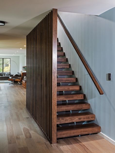 The foyer of the home was completely remodeled and now features matching Mercier engineered wood flooring. Vertical screen wall made with walnut stained wood as well as the floating staircase. A custom metal staircase was painted dark bronze and shows no bolts for a clean look. Walnut Staircase, Scandinavian Minimalist Interior, Wooden Staircase Design, Baddie Bedroom, Stair Railing Design, Staircase Makeover, Wood Staircase, Floating Stairs, Floating Staircase