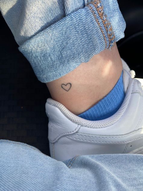 Tiny Blue Heart Tattoo, Simple Heart Tattoo Designs Ideas, Leg Heart Tattoo, Simplistic Heart Tattoo, White Tattoo Heart, Small Heart Tattoo Placement, Heart On Ankle Tattoo, Heart Foot Tattoo, Lil Heart Tattoo