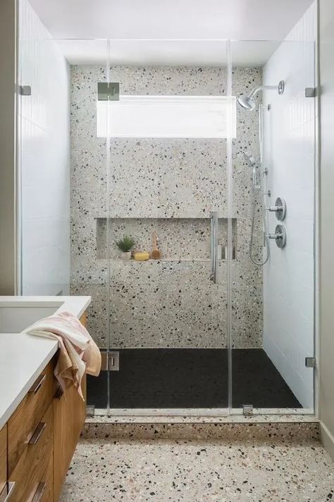 a modern bathroom clad with neutral terrazzo, with a shower space, a stained vanity, a window in the shower for a fresher feel Terrazzo Bathroom Floor, Terrazzo Bathroom Design, Neutral Terrazzo, Bathroom Terrazzo, Tile Shower Niche, Terrazzo Bathroom, Accessible Bathroom Design, Window In Shower, Bathroom Shower Tile