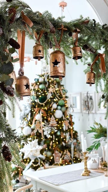 🔔🔔We just had to JUMP on this TREND … and we had to step it up a notch and add some of our BELLS!! What do you think? Would you try this trend? 🔔How did we do it? 🤎🤎We used a curtain tension rod and added some CHRISTMAS garland. I attached ours with green pine pipe cleaners.🤎🤎Tighten the tension rod between your walkway!! 🤎🤎Cut the jute off the bells and add some ribbon to your bells!! Simply tie the bells on the rod at varying lengths. This was about a 10 minute project with amazing results. I love the way it frames the Christmas tree!!🔔🔔Make sure to shop our entire collection of bells. What do we love about our bells with the star cutout? -they are perfect for other holidays!! Think Christmas, 4th of July and even Halloween!! Garland With Bells And Ribbon, Curtain Rod Garland Trend, Tension Rod Garland, Christmas Decor Inspiration, Tension Rod, Pipe Cleaners, Xmas Ideas, Pipe Cleaner, Christmas 2024