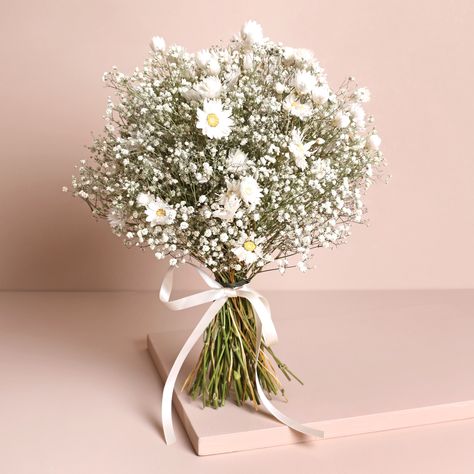 An elegant wedding bouquet plucked right out of the English countryside. Transport your special day to the blissful outdoors with our glorious Dorothy dried flower range. Specially crafted for weddings, each collection has something to suit your ensemble. With natural gypsophila and rodanthe daisies arranged by our in-house team, each bouquet is finished with a white ribbon for comfortable holding.This bouquet has been specially designed to stand upright, for all those moments during your celebrations when you're unable to carry it. This also makes it ideal for displaying in your home after your wedding - simply pop it pride of place and remember the joy of your special day every time it catches your eye.Dried flowers will last a long time, but if you look after them correctly, they will l Wedding Flowers Gypsophila, Flower Bridesmaid, Gypsophila Bouquet, Elegant Wedding Bouquets, White Flower Bouquet, Bridal Wedding Bouquet, White Floral Arrangements, Green Wedding Flowers, Button Holes Wedding