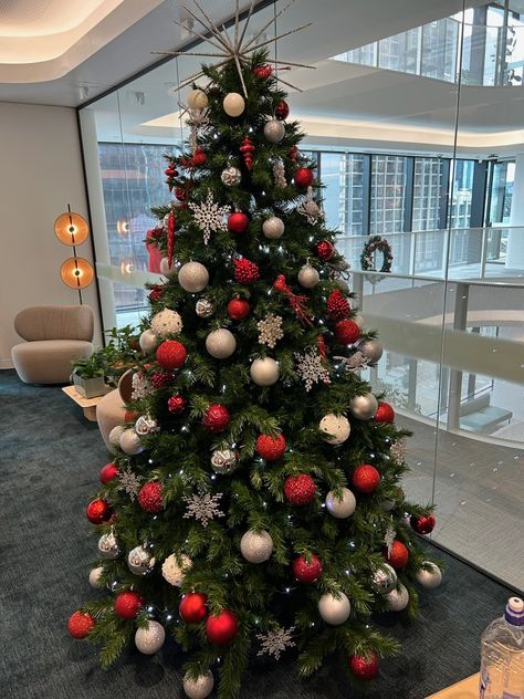 Red, white and silver decorations bring a modern freshness to this artificial decorated Christmas tree in an office reception in Melbourne. Christmas Tree In Office, Red And White Christmas Tree Simple, Reception Christmas Decorations Office, Christmas Tree Silver And Red, White Silver And Red Christmas Tree, Red White And Silver Christmas Decor, Red White And Silver Christmas Tree, Red White Silver Christmas Tree, Red And Silver Christmas Decor