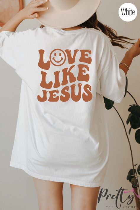 Enhance your style while showcasing your unwavering faith with our vibrant Jesus Shirt. This elegant and fashionable Christian apparel adds a pop of color to your wardrobe, instantly grabbing attention. Let your clothing become a powerful reflection of your beliefs and stand out from the crowd. Discover a unique way to express your devotion through fashion. #FaithFashion #ChristianApparel #FashionableFaith Christian Drip, Trendy Tshirt Designs, Christian Clothes, Faith Tshirts, Christian Shirts Designs, Christian Merch, Jesus Sweatshirts, Hoodie Ideas, Trendy Tees