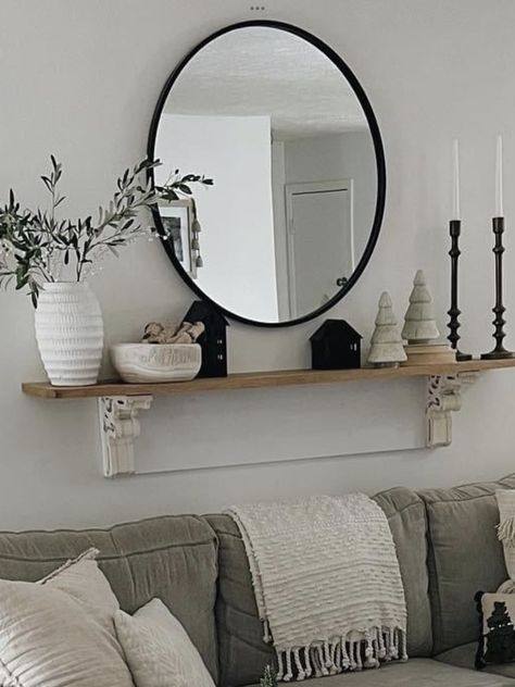 Wall Decor With Round Mirror Living Room, Large Round Mirror Dining Room Wall, Mirror And Shelf Above Couch, Round Shelf Above Couch, Black Circle Mirror Living Room, Living Room Circle Mirror, Big Mirror Above Couch, 3 Circle Mirrors On Wall Ideas, Mirror Wall Decor Living Room Floating Shelves