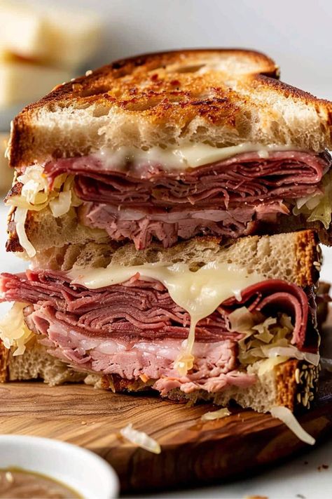 This hot pastrami sandwich gives major New York deli vibes! The combo of pastrami, Swiss cheese, sauerkraut, Russian dressing, and rye bread is to die for. Pastrami Melt Sandwich, Best Pastrami Sandwich Recipe, Pastrami On Rye Sandwich, Grilled Pastrami Sandwich, New York Deli Sandwiches, Ruban Sandwich Recipes, Best Hot Sandwich Recipes, Katz Deli Pastrami Recipe, 60 Sandwiches