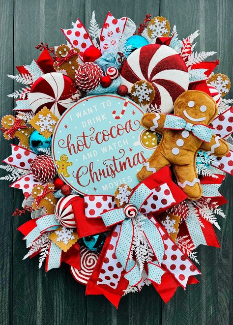 Decorate your front door this holiday season with this adorable Christmas wreath! This large handmade wreath is built on a pine base and measures approximately 32 inches (L), 26 inches (W), and 10 inches (D) tip to tip. It features a large metal sign with the message "I want to drink hot coca and watch Christmas movies". This wreath is adorned with deco mesh, high quality ribbons, a plush gingerbread man, peppermint lollipops, various ball ornaments, white glittered fern sprays, red glittered be Bright Red Christmas Decor, Gingerbread Man Christmas Wreath, Christmas Wreaths Candy, Gingerbread Decorations Christmas, Gingerbread Wreath Diy, Peppermint Christmas Decorations Diy, Gingerbread Wreaths Christmas, Red White Blue Christmas, Peppermint Christmas Decorations