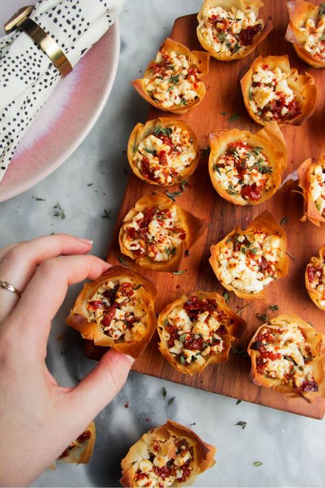 Quick, easy, festive colours, deep flavour...there's a lot to love about these sundried tomato feta filo cups. Pop filo in a mini muffin tin, then top with a speedy mix of feta, sundried tomatoes, thyme and feta and bake until golden. A simple, crowd-pleasing appetizer to impress. Feta Cheese Appetizer Recipes, Sun Dried Tomato Appetizer Recipes, Filo Pastry Appetizers, Fall Apps For Party, Filo Appetizers, Sundried Tomato Appetizer, Autumn Appetizers For Party, Sun Dried Tomato Appetizer, Appetizer Recipes Fall