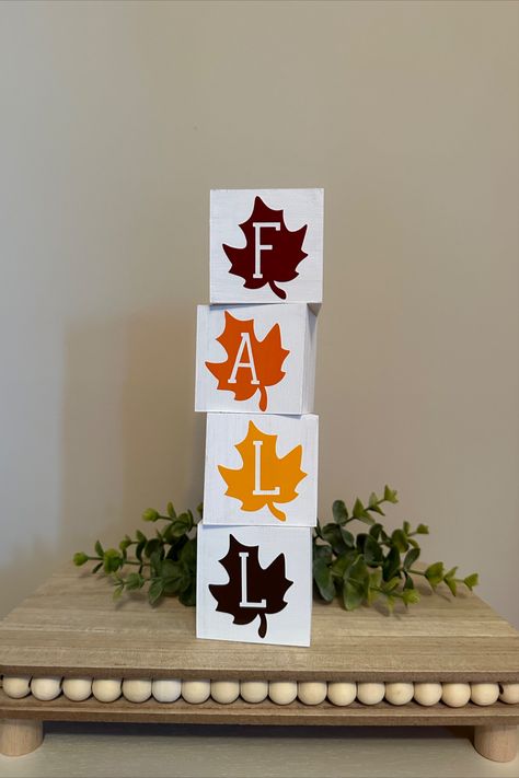 These decorative blocks are the perfect addition to your fall and Thanksgiving decor, bringing a warm and cozy feel to any room. The blocks feature beautiful fall leaf designs that will capture the essence of the season. They can be stacked together or displayed separately, allowing you to create your own unique arrangement. Not only do these blocks make a great addition to your own home, but they also make a thoughtful hostess gift for Thanksgiving celebrations. Wooden Ideas Handmade, Wood Thanksgiving Decor, Diy Wood Blocks Decor, Fall Blocks Wood Crafts, Fall Craft Fair Ideas To Sell, 2 X 4 Crafts, Wooden Blocks Decor Craft Ideas, Thanksgiving Diy Decorations, Scrapbook Cards Ideas