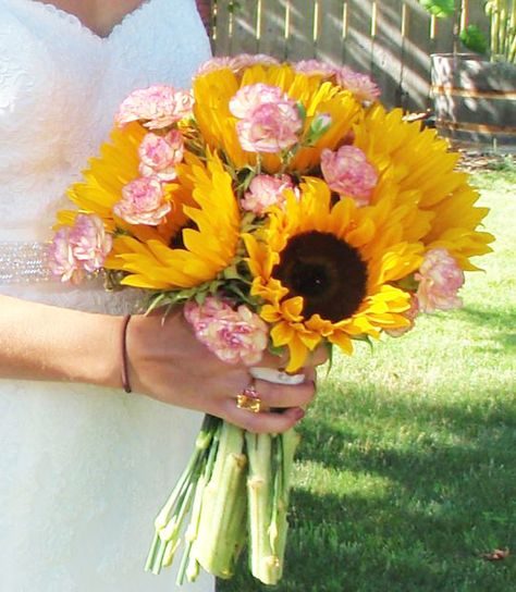 Here is a simple version.  Yours could be similar to this with red flowers and baby's breath. Sunflower And Carnation Bouquet, Sunflower Pink Bouquet, Pink And Sunflower Wedding, Hannah Flowers, Simple Bouquet, Wedding Flowers Hydrangea, Gorgeous Bouquet, Sunflower Centerpieces, Bright Wedding Flowers