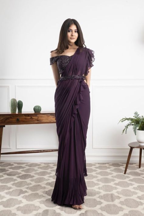 Sarees are a great way to add a touch of elegance and sophistication to any outfit. They can be worn for work, dinner, or even the weekend. There are some things to know about sarees before buying one, so read our guide first! From fabric types to stitched borders, we will cover everything you need to know to find the perfect saree for your needs. Purple swirling itâ€™s magic! A statement blouse with pre draped ruffle saree is exactly what you need for a wedding! A collection which is exquisite Hairstyle For Ruffle Saree, Style Saree Modern, Freshers Saree Ideas, Saree Graduation Look, Saree Type Dress, Basic Lehenga, Saree Outfit For Farewell, Freshers Saree Look, Hairstyles On Saree For Farewell