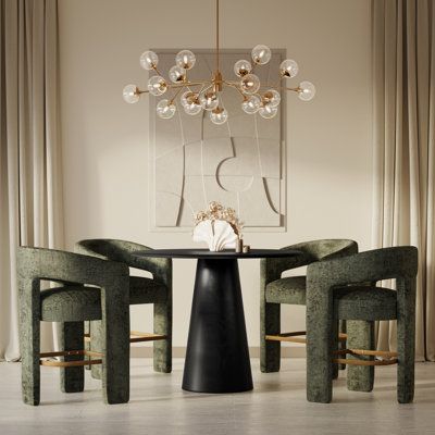 Our 5-piece dining set is a step above the rest with its space-conscious design and inviting mixed-materials look. It includes a round table and four armchairs fully wrapped in plush jacquard fabric. The table is crafted from solid and engineered wood with a black finish, and the circular table top rests on a classic pedestal base for a dynamic mod vibe we love. Measuring 45" wide, the table can easily accommodate up to four people. Chair Color: Forest Green | Orren Ellis Tiarah - Person Counter Cocktail High Table, Round 4 Seater Dining Table, Dining Room Sets Modern, Modern Kitchen Table And Chairs, Modern Luxury Dining Room, Round Counter Height Table, Black Round Dining Table, Dining Table Walnut, Dining Area Design