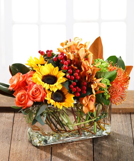 thankslongcenterpiece A sophisticated, contemporary floral design, artfully arranged in a modern glass featuring autumn roses, pincushion protea, sunflowers, southern green hydrangea, exotic orchids, hypericum berries and fall foliage & accents.  Every Carithers arrangement is custom designed and hand-delivered just for you. Available for delivery throughout metro Atlanta Thanksgiving Flower Arrangements, Luxury Flower Arrangement, Contemporary Floral Design, Autumn Roses, Pincushion Protea, Fall Floral Centerpieces, Thanksgiving Floral, Sunflower Arrangements, Hydrangea Arrangements