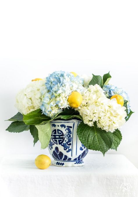 Elegant, inexpensive, southern blue and white floral centerpiece with yellow lemons Southern Flower Arrangements, Lemon Hydrangea Centerpiece, Lemon Floral Arrangements, Lemon Arrangements, Fruit And Flower Arrangements, Lemon Centerpiece Ideas, Thanksgiving Fruit, Lemon Centerpieces, Hydrangea Arrangement