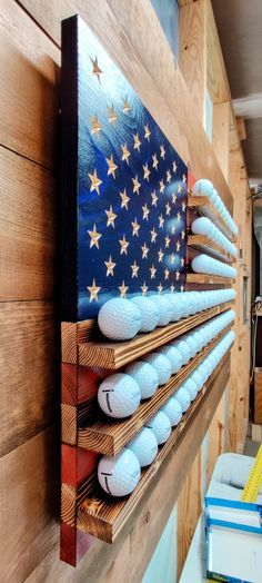 "High quality and very well built! This beautiful American Golf Ball Display is an awesome way to display your accomplishments and mementos from the green. Truly a perfect gift for any golfer, it features 6 shelves to hold up to 87 golf balls. Each shelf has circular grooves cut into them to keep the balls in place. It is 19\" x 37\" in size. The stars are perfectly carved (not painted), creating a gorgeous addition to your home. Golf balls shown are not included. The front and back are protecte Golf Ball Collection Display, Golf Woodworking Projects, Man Cave Display Ideas, Wood Golf Projects, Golf Ball Holder Display, Diy Golf Ball Display, Golf Display Ideas, Golf Ball Display Ideas, Golf Flag Display Ideas