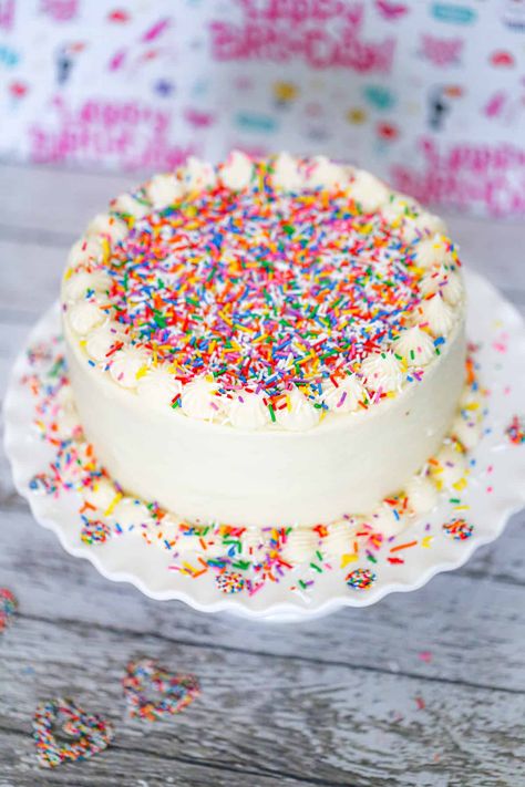 It's always a celebration when the Rainbow Sprinkle Cake comes to the party!  This layered vanilla cake is light, fluffy, and melt-in-your-mouth yummy with lots of fun, vibrant multi-colored sprinkles, paired with the best vanilla frosting with even MORE sprinkles on top! No celebration is complete without a funfetti layer cake! #funfetti #cakewithsprinkles #sprinkles #birthdaycake #sprinklecake #rainbowcake #rainbowsprinkle #sprinkledessert Colorful Birthday Cake Ideas, Plain Cake With Sprinkles, Rainbow Confetti Cake, White Sprinkle Cake, White Cake With Sprinkles, Birthday Cake With Sprinkles, Funfetti Cake Mix Recipes, Rainbow Sprinkle Cake, Confetti Birthday Cake