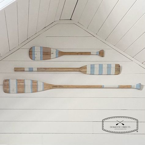 "Elevate your home decor with our beautifully handmade painted paddle wall art, a true testament to the timeless allure of coastal living. Inspired by the rustic beauty of the ocean, this hand-painted masterpiece brings a touch of seaside serenity right into your living space.  SIZES Small 35.25\" (89.5cm) length X up to 5.75\" (14.5cm) wide Medium 48\" (122cm) length X up to 5.75\" (14.5cm) wide Large 54\" (137cm) length X up to 5.75\" (14.5cm) wide STYLE  Choose from paint style  #1,#2 or #3 OUTDOOR/INDOOR These are made with the intention of being used for indoor wall decor, do don't expose to elements.  COLOR Natural unfinished wood with ivory and light coastal blue paint. Intentionally distressed/antique finish. HANGING OPTIONS Does not come with hardware as everyones wall situation a Beach House Color Palette, Coastal Blue Paint, Oar Decor, Painted Paddles, Beach House Colors, Lake Retreat, Lake House Interior, Beach House Wall Art, House Wall Art