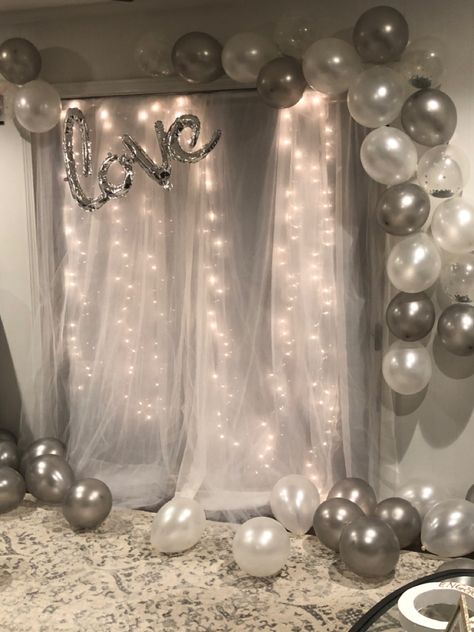 Tulle backdrop with lights + gray, gray confetti, and pearl white balloons Simple Decorations For Anniversary, Pearl White Party Decorations, Birthday Decorations With Lights, White And Silver Photo Backdrop, White Themed Birthday Party Decorations, White And Shimmer Party, White And Grey Birthday Decorations, Tulle Birthday Decorations, Tulle Backdrop With Balloons