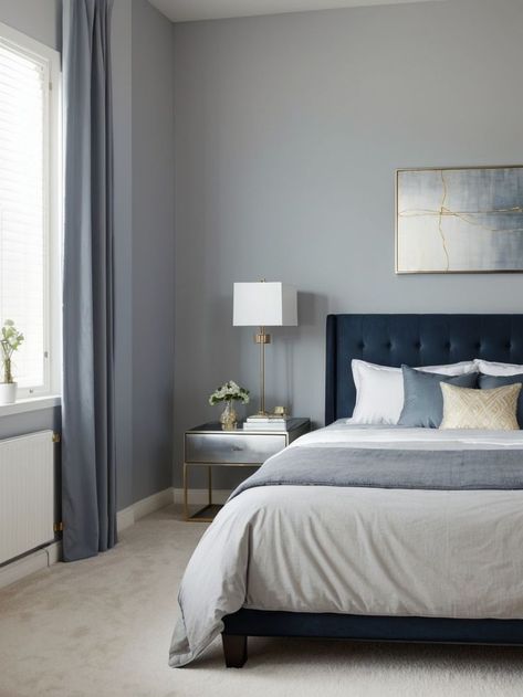 Create a calming atmosphere in your bedroom with blue-gray walls adorned with framed abstract art. Add a touch of elegance by incorporating metallic accents such as silver or gold picture frames. Steel Blue Bedroom Ideas, Navy And Silver Bedroom, Beige And Navy Bedroom, Navy Grey Bedroom, Dark Blue And Grey Bedroom, Blue Grey Bedroom Ideas, Navy And Beige Bedroom, Navy Blue And Grey Bedroom, Blue And Grey Bedroom Ideas