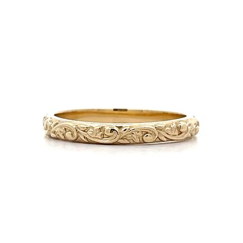 Designed in house by our expert jewelers – this custom modern wedding band is vintage inspired and beautiful. This new By Filigree engraved wedding band features a floral engraved pattern in 14 karat yellow gold. The swirling floral motif decorates the outer shank of the 2.79mm wide band. An unconventional wedding band that is truly unforgettable. Pair this wedding ring with a Yellow Gold Engagement Ring or wear in a right hand stack! Baroque inspired and modern made. Embossed Engagement Ring, Vintage Floral Wedding Band, Gold Filigree Engagement Ring, Ornate Wedding Band, Antique Wedding Bands For Women, Intricate Wedding Band, Carved Wedding Band, Engraved Engagement Ring Band, Art Deco Gold Ring