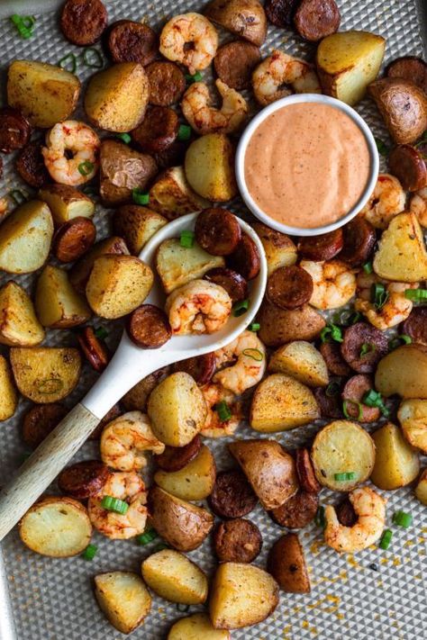 This Easy Cajun Sheet Pan Meal is made with succulent shrimp, andouille chicken sausage, and baby red potatoes with a delicious comeback sauce! All cooked together in one pan it is such an easy weeknight sausage, potato and shrimp sheet pan dinner recipe packed with smoky Cajun flavors. Cajun Sheet Pan, Sausage And Shrimp Recipes, Easy Cajun, Comeback Sauce, Sausage Sauce, Baby Red Potatoes, Sheet Pan Suppers, Sheet Pan Dinners Recipes, Baby Red