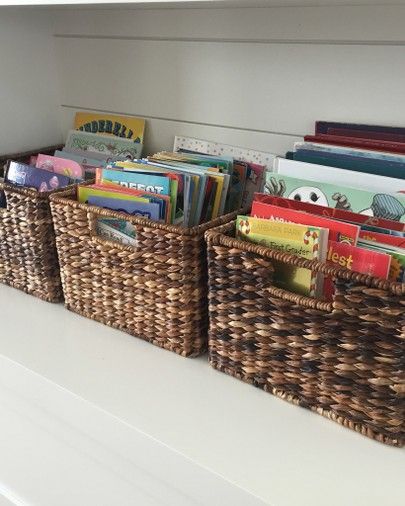 Organize kids books in baskets on a shelf to keep the play room neat and organized. Teach your children how to clean and organize!  -  Neatly Designed, organizer, organizing expert, clearing the clutter, home decor, simple, simplicity, professional, the container store, Ikea, hacks, tips and tricks, renovation, DIY, decoration, house, home, ideas, living room, bedroom, bathroom, office, kitchen, organize, design, how to, interior, garage, Jacksonville, florida, Atlantic beach, Ponte Vedra Baskets For Books, Baskets For Book Storage, How To Keep Books Organized, Book Storage Ideas Living Room, Baby Book Organization, Book Basket Storage, Basket Of Books, Kid Book Storage Ideas, Children Book Storage