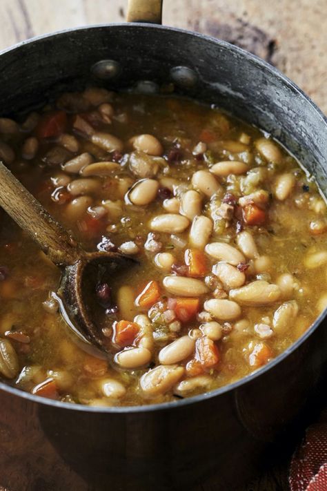 Ina Garten's Tuscan White Bean Soup is made with cannellini beans, pancetta, leeks, onions, carrots, celery, garlic, rosemary, chicken stock, and Parmesan cheese. This hearty Tuscan White Bean Soup recipe creates a delicious dinner that takes about 2 hours , including soaking time, to prepare and can serve up to 6 people. Ina Garten Tuscan Bean Soup, Ina Garten Tuscan Soup, Ina Garten Tuscan White Bean Soup, Soup With White Beans, Garlic Rosemary Chicken, Tuscan White Bean Soup, Pesto Soup, Cannellini Beans Recipes, Tuscan White Bean