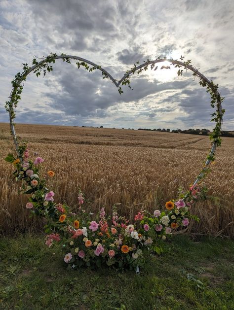 Floral wedding heart arch Heart Shape Decorations Wedding Ideas, Heart Shaped Arch For Wedding, Heart Shape Wedding Arch, Backyard Floral Wedding, Wedding Arch Heart, Wedding Arch Shapes, Heart Shaped Wedding Arch, Heart Arch Wedding Decoration, Wedding Arch Sunflowers