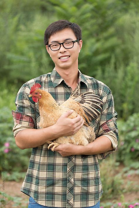 A young male farmer holding chicken by Maa Hoo for Stocksy United Farmer Poses Drawing, Holding Chicken Reference, Farmer Drawing Reference, Farmer Pose Reference, Person Holding Bird, Farmer Reference, Simple Chicken Drawing, Drawing Of A Chicken, Chicken Drawing Cute