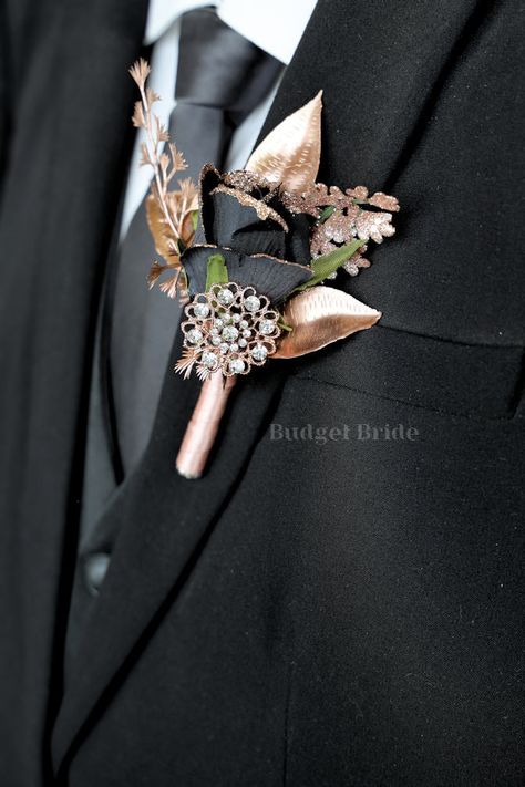 Mens lapel boutonniere with 1 black rose with rose gold glitter tips accents with rose gold leaves and a rose gold jewel. The stems of this boutonniere are wrapped in rose gold ribbon The perfect boutonniere for a navy blue and silver theme wedding!! Color changes are free - if you like this boutonniere but in a differ Navy Blue And Rose Gold Tuxedo, Black And Rose Gold Suits For Men, Black And Rose Gold Rustic Wedding, Black And Rose Gold Tuxedo, Black And Rose Gold Groomsmen Attire, Rose Gold Blush Pink And Black Wedding, Black Burgundy And Rose Gold Wedding, Rose Gold Black Wedding Theme, Black Silver Gold Wedding