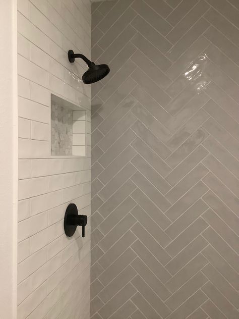 Herringbone On One Shower Wall, Bathroom Chevron Tile, Dark Shower Floor Light Walls, Herringbone And Subway Tile Bathroom, Herringbone Tile Bathtub Wall, Lake House Shower Tile Ideas, Herringbone Backsplash Bathroom Shower Walls, Small Bathroom Herringbone Tile, Chevron Subway Tile Bathroom