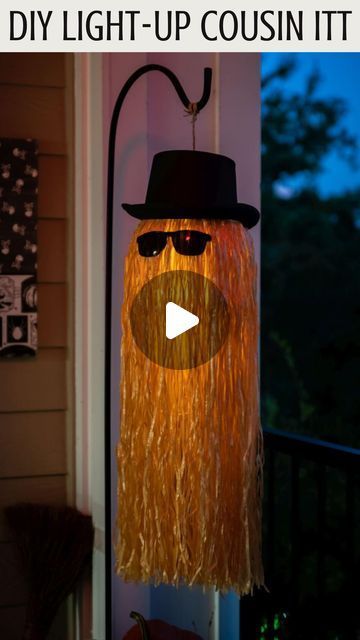 DIY Cousin Itt Pathway Light | DIY Addams Family Cousin It | Step-by-step tutorial for how to make a Cousin It | DIY Halloween decor with Dollar store supplies | Upcycled and Repurposed Halloween decor | Plastic pumpkin candy pail upcycle | Halloween Yard decoration ideas | Hula skirt upcycle | DIY Dollar Tree Halloween craft ideas | #TheNavagePatch | TheNavagePatch.com Dollar Tree Hula Skirt Crafts, Cousin It Decoration, Halloween Pumpkin Bucket Ideas, Farmhouse Halloween Decor Diy, Halloween Decorating Ideas For Outside, Halloween Bucket Ideas, Cheap Diy Halloween Decorations Outdoor, Cousin It Diy, Pumpkin Decorations Diy