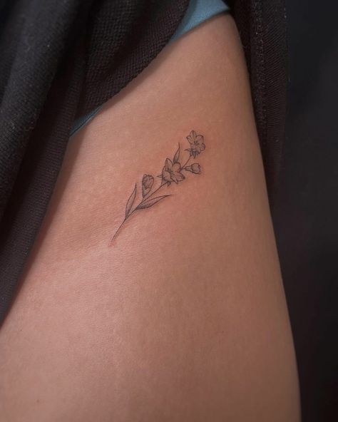 Minimalist Floral Hip Tattoo, Tattoo Ideas Jasmine Flower, Come Flower Tattoo, Lokelani Flower Tattoo, Hidden Flower Tattoos, Classy Rose Tattoo, Torso Flower Tattoo, Small Lily Flower Tattoo Simple, Dainty Fine Line Flower Tattoos