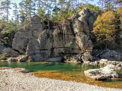 A rock wall looks down upon a clear water river in the Ouachita National Forest Ouachita National Forest, Ouachita National Forest Arkansas, Draw Forest, Jasper Arkansas, Arkansas Road Trip, Arkansas Vacations, Ozark National Forest, Oklahoma Travel, Arkansas Travel