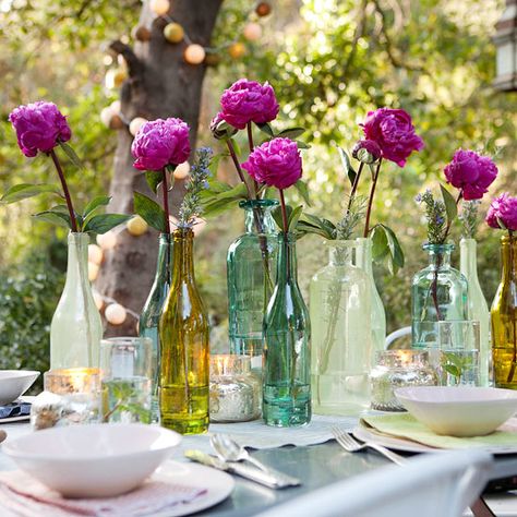 Add fresh-cut flowers to mixed vases for a relaxed outdoor table display. See the rest of this alfresco affair: http://www.bhg.com/party/birthday/themes/outdoor-party-idea-alfresco-affair/?socsrc=bhgpin050813mixvases=3 Wedding Reception Centerpieces Diy, Colored Bottles, Fish Party, Dinner Party Table Settings, Beautiful Wedding Centerpiece, Creative Centerpieces, Idee Babyshower, Diy Wedding Reception, Tafel Decor