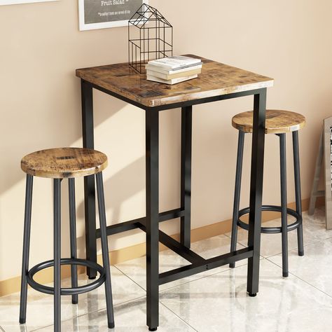 PRICES MAY VARY. [Space Saving Kitchen Table Set] ----- The stools can be moved under the table when not in use, it is a nice solution for small spaces, such as limited kitchen, studio apartment or balcony. Improve the utilization of your space. [3 Pieces Bar Table Set] ----- 1- piece square coffee table and 2-piece round barstools. Both the table and chairs are made of quality MDF board covered with black grain PVC and black coated metal frame for a chic look. Metal frame of table and stools en Round Barstools, Small Space Bar, Space Saving Kitchen Table, Rustic Dining Set, Space Bar, Bar Table And Stools, Kitchen Studio, Space Saving Kitchen, Bar Table Sets