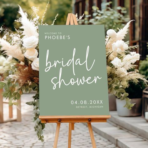 [PaidLink] Make A Stylish And Chic First Impression With This Sage Minimalist Script Bridal Shower Welcome Sign. This Modern Bridal Shower Decor Features A Simple Yet Elegant Minimalist Script Font That Effortlessly Sets The Tone For A Sophisticated Soiree. With Its Minimalist Script Font And Calming Sage Green Color, This Sign Is Perfect For The Modern Bride Who Wants Her Bridal Shower Decor To Feel Chic And Refined. Hang This Beautiful Welcome Sign To #simpleneutralbridalshowerdecor Bridal Shower Ideas Plant Themed, Bridal Shower Decorations Elegant Brunch, Sage Green Engagement Party Decor, Succulent Themed Bridal Shower Ideas, Green Wedding Shower Ideas, Wedding Shower Decor Ideas, Bridal Shower Ideas Sage Green, Diy Bridal Shower Sign, Green And White Bridal Shower Decor