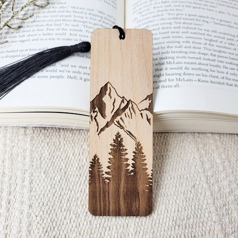 Add a touch of nature to your next novel with these beautiful eco-friendly wooden bookmarks. All bookmarks are engraved in-house using sustainably sourced American hardwood. After your new bookmark is engraved, it is finished with a black bookmark tassel. Best of all, this product is all-natural, so you can feel good about shopping small AND eco-friendly! Material: sustainable American hardwood, unfinished Sizing: 1.7 inch L x 5 inch W Thickness: 1/16 inch Wooden Bookmarks Handmade, Diy Wooden Bookmark, Wood Burning Bookmark Ideas, Wooden Bookmark Ideas, Woodburn Bookmarks, Wooden Bookmarks Diy, Small Wood Burning Ideas, Wood Burning Bookmarks, Woodburned Bookmarks