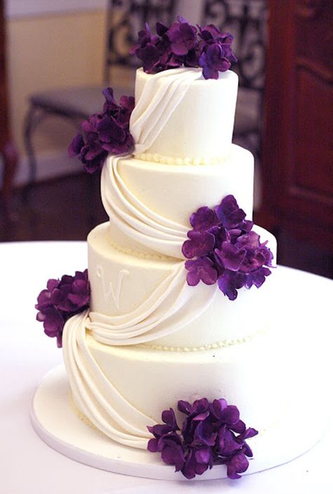 white fondant drape wedding cake with purple hydrangeas Drape Wedding Cake, Purple Wedding Cake Ideas, Wedding Cake Designs Purple, Buttercream Ruffle Cake, Wedding Cake With Purple, Wedding Cake Hydrangea, Orchid Wedding Cake, Gray Wedding Cake, Purple White Wedding